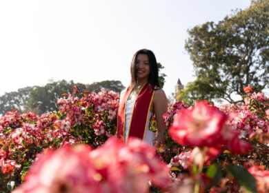 Woman standing in pink flower garden