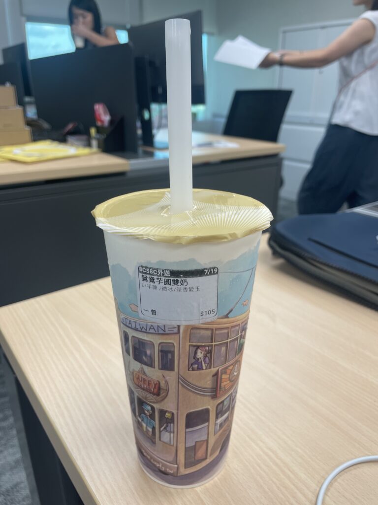 A tall plastic cup filled with Boba tea.