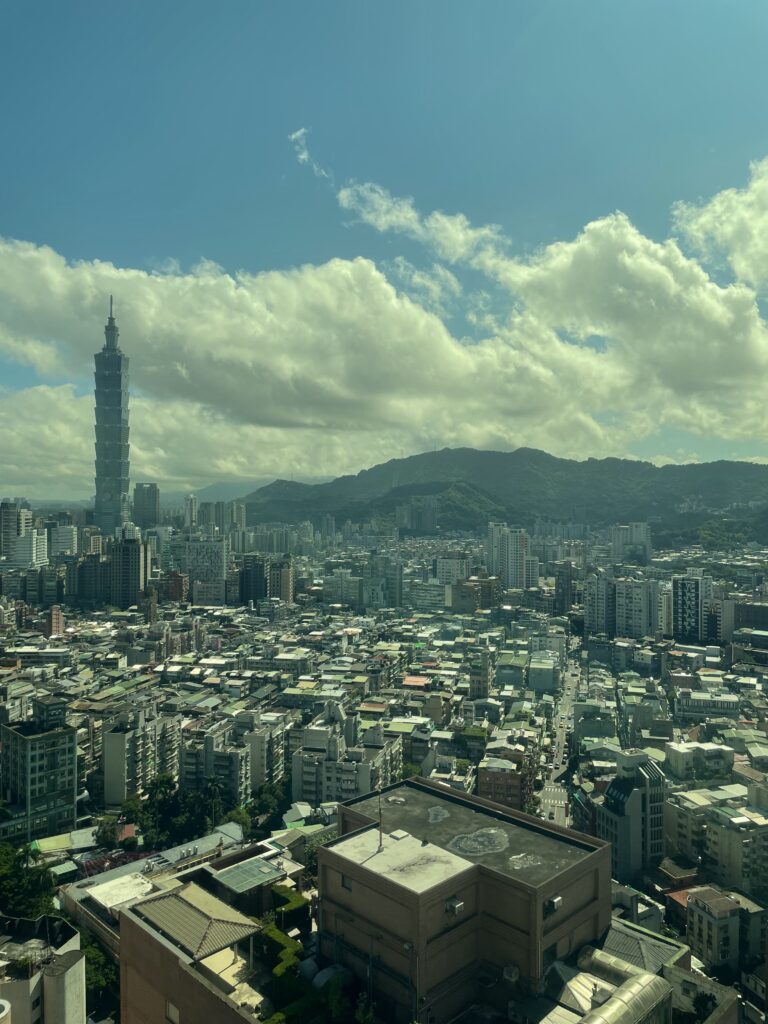 Taipei City's crowded skyline with an immense number of buildings and mountains in the backdrop.