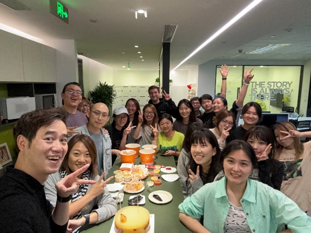 Group of Professionals enjoying a festive birthday lunch of fried chicken and cake.