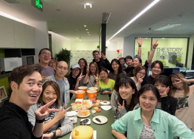 Group of Professionals enjoying a festive birthday lunch of fried chicken and cake.