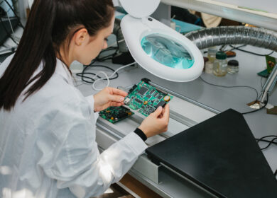 Female scientist in a lab analyzing a semiconductor chip.