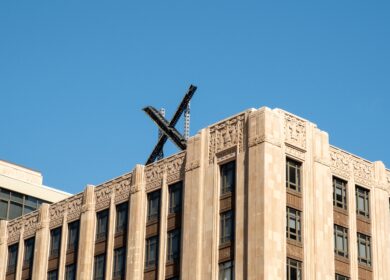 Photo of X logo atop a building.